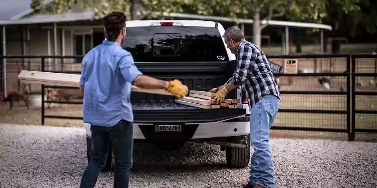 Pickup truck with TOFF bed liner being loaded with wood