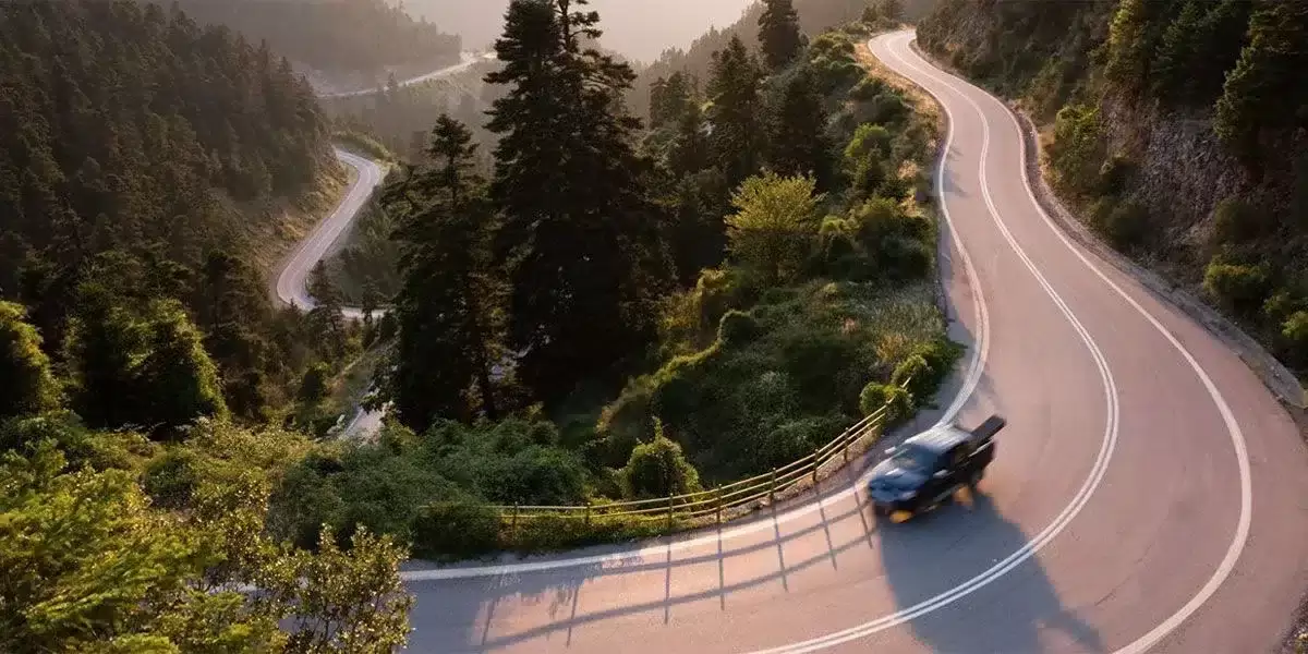 Pickup truck driving on a road with TOFF bed liner